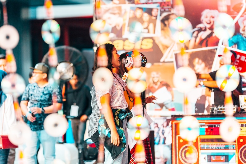 A woman singing at the Karaoke Zone at Festival Mesin Waktu