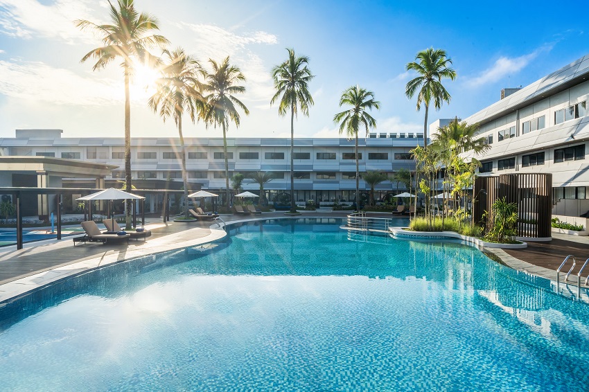 Families are welcomed with amenities including a Kids Club and a Kids Splash Pool with water sprayers and a tipping bucket. Parents can unwind at the tropical-inspired swimming pool or indulge in restorative treatments at In Balance Spa and Fitness, designed to promote longevity and harmony.